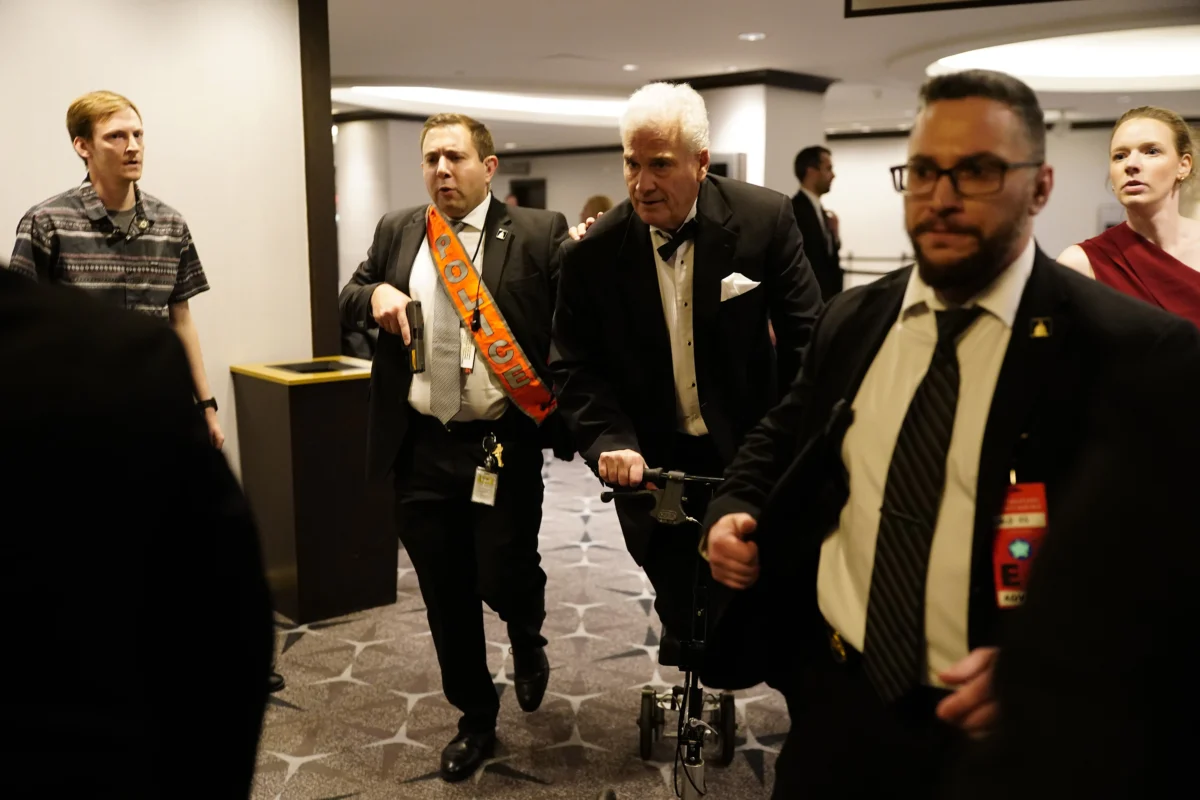 Agents escort people out after an incident at the annual White House Correspondents Association Dinner in Washington on April 25, 2026. (Nathan Howard/Getty Images)