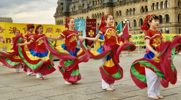 Young Falun Dafa practitioners participate in a dance performance as part of activities to celebrate World Falun Dafa Day on Parliament Hill in Ottawa on May 5, 2026. (Jonathan Ren/The Epoch Times)