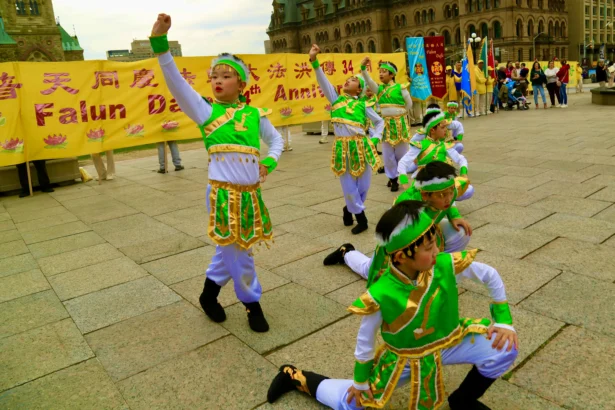 Young Falun Dafa practitioners participate in a dance performance as part of activities to celebrate World Falun Dafa Day on Parliament Hill in Ottawa on May 5, 2026. (Evan Ning/The Epoch Times)