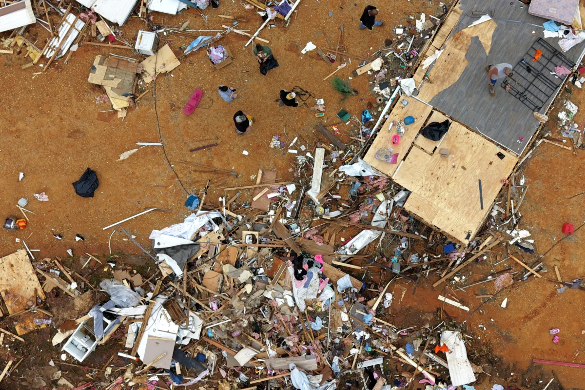 People walk among debris at Gene's Mobile Home Supply, a trailer park in Bogue Chitto, Miss., on May, 7, 2026, after a tornado cut across the state. (Gerald Herbert/AP Photo)