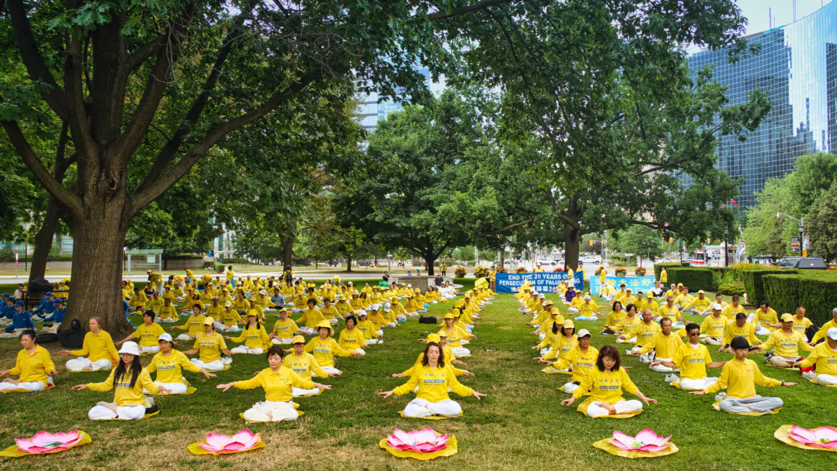 Falun Gong practitioners demonstrate the practice's sitting meditation exercise during an event held at Queen's Park in Toronto on July 13, 2025, to commemorate the 26th anniversary of the Chinese Communist Party's persecution of Falun Gong. (Jerry Zhang/The Epoch Times)