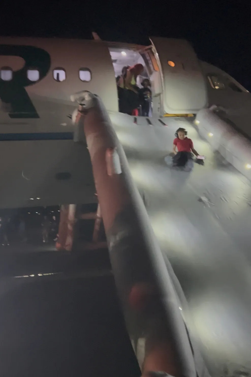 Passengers evacuate a airplane after a person was struck and killed by a Frontier Airlines plane during takeoff, at Denver International Airport in Denver on May 8, 2026. (Jack Estenssoro via AP)