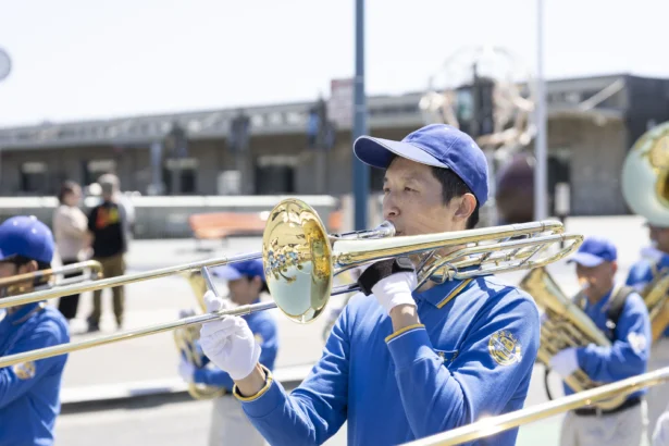 David Shi parades in the Tian Guo Marching Band on May 9 in San Francisco. (Lear Zhou/The Epoch Times)