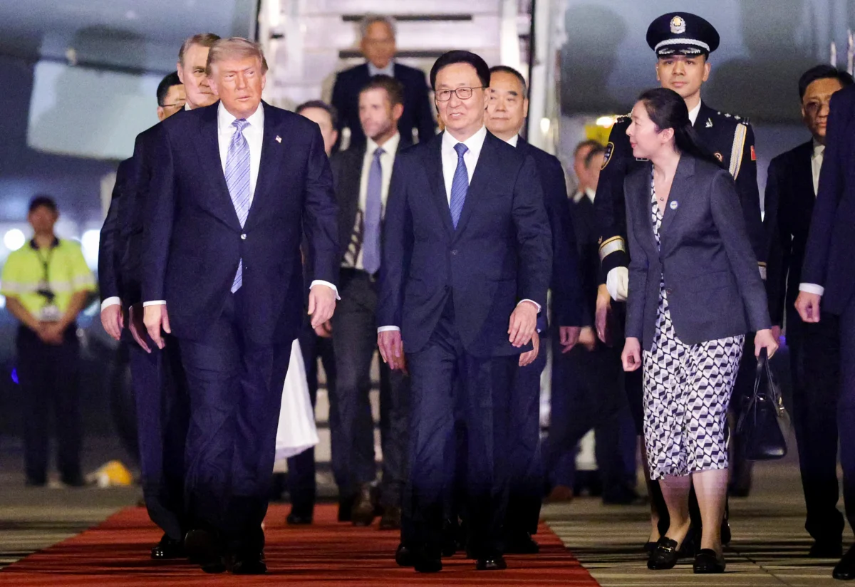 Vice President of China Han Zheng (C) escorts U.S. President Donald Trump (L) as he arrives at Beijing Capital International Airport in Beijing, China, on May 13, 2026. (Alex Wong/Getty Images)
