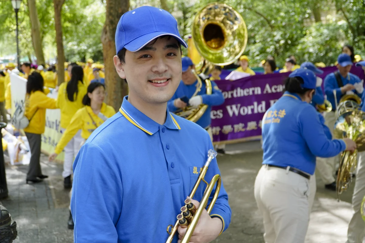 Mark Yang, 27, Yang says his mother practiced Falun Gong even before he was born. He is standing Dag Hammarskjöld Plaza, where practitioners of Falun Gong prepare for a parade celebrating World Falun Dafa Day on May 13, 2026. (Nicholas Zifcak/The Epoch Times)