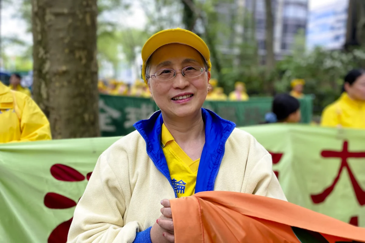 April Zhang, 56, suffered from asthma long term before taking up Falun Gong. She joined the parade in Manhattan to celebrate World Falun Dafa Day on May 13, 2026. (Nicholas Zifcak/The Epoch Times)