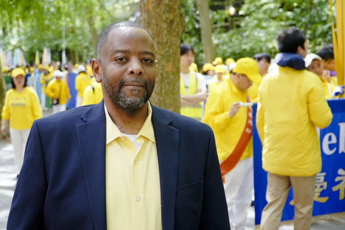 Lawrence Rweyemamu, 50, has practiced Falun Gong since 2009. He is standing Dag Hammarskjöld Plaza, where practitioners of Falun Gong prepare for a parade celebrating World Falun Dafa Day on May 13, 2026. (Nicholas Zifcak/The Epoch Times)