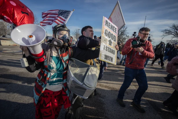 Protestors face-off with federal officers in front of the Bishop Henry Whipple Federal Building in Minneapolis, MN., on Jan. 9, 2026. (John Fredricks/The Epoch Times)