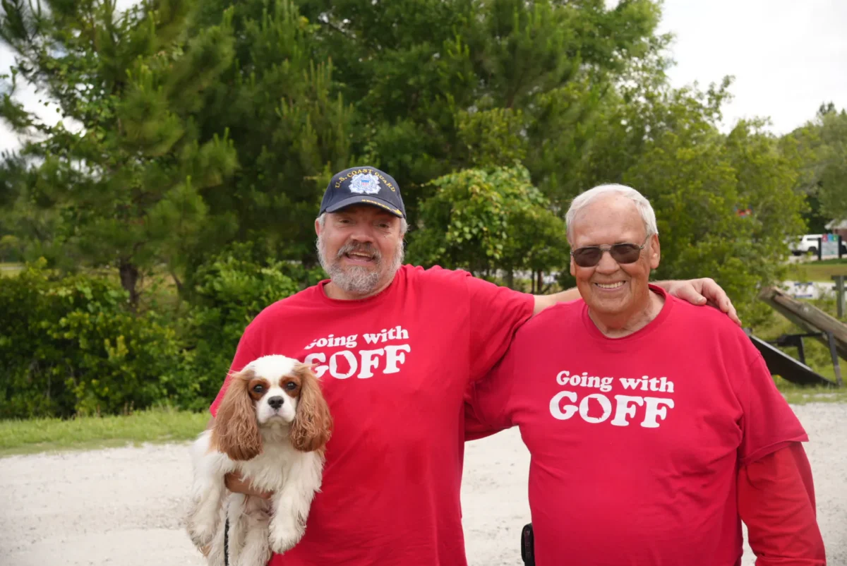 Joe Kaminski (L) is holding his dog Kirby alongside Clayton Ben Goff, who is running to be a county commissioner in Camden County, Georgia. The pair were outside a polling location on primary election day in St. Marys, Georgia, on May 19, 2026. (Troy Myers/Epoch Times)