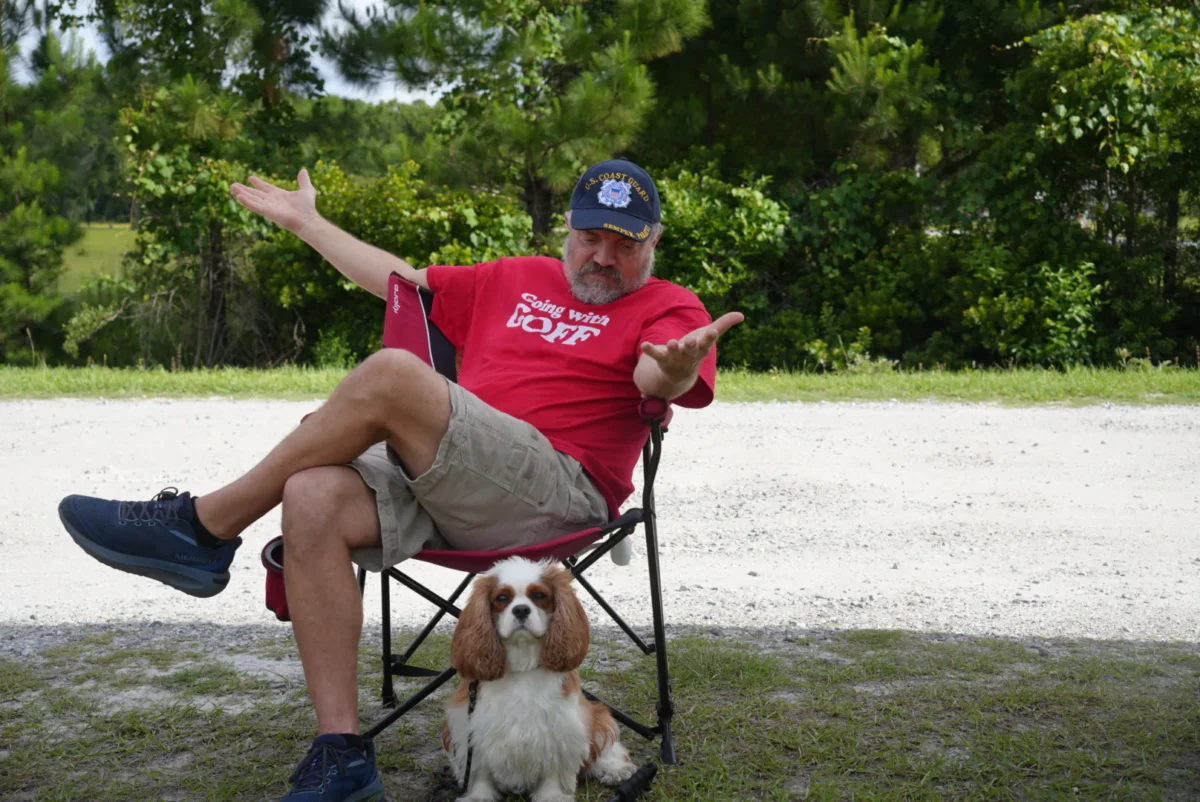 Joe Kaminski and his dog Kirby were signing outside a small voting precinct in Georgia. They waved at other voters passing by, and Kaminski explained his frustration with no younger candidates running for governor of the Peach State in the primary election on May 19. (Troy Myers/Epoch Times)