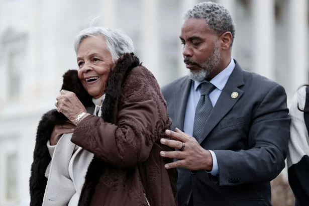 Rep. Steven Horsford (D-Nev.) helps Rep. Bonnie Watson Coleman (D-N.J.) (L) put on her coat during a press conference introducing The Justice for Breonna Taylor Act outside the U.S. Capitol Building in Washington on Dec. 10, 2025. (Heather Diehl/Getty Images)