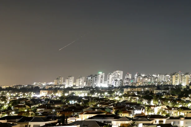 A streak of light illuminates the sky during a missile attack from Iran toward Israel, as seen from Ashkelon, Israel, on June 7, 2026. (Amir Cohen/Reuters)