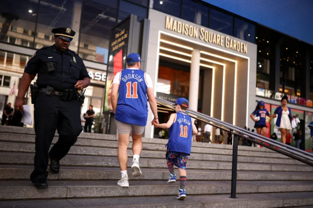 New York Knicks fans and New York Police Department officers gather outside Madison Square Garden ahead of the NBA Finals game 3 between the New York Knicks and the San Antonio Spurs, in New York City on June 8, 2026. (Charly Triballeau/AFP via Getty Images)