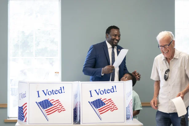 Gubernatorial candidate Rep. Jermaine Johnson (D-Richland) (L) accompanied by his son, Kobe, shares a laugh after completing a ballot during early voting at the Garners Ferry Adult Activity Center in Hopkins, S.C., on May 26, 2026. (Sean Rayford/Getty Images)