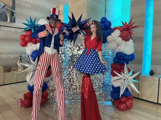 Patriotic stilt-walkers Jeffrey DeBarathy and Sarah Roberts greeted voters at the Las Vegas City Hall during the primary election on June 9, 2026. (Jacki Thrapp/The Epoch Times)