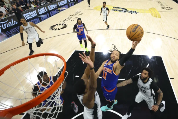 New York Knicks guard Jalen Brunson (11) drives to the basket past San Antonio Spurs forward Julian Champagnie (30) during game five of the 2026 NBA Finals at Frost Bank Center in San Antonio, Texas, on June 13, 2026. (Geoff Burke/Pool via Imagn Images via Reuters)