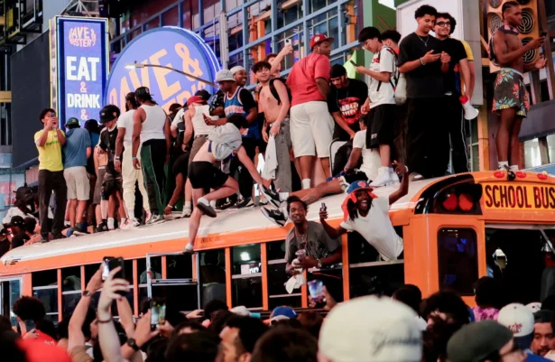 Fans celebrate the New York Knicks' win against the San Antonio Spurs in Game 5 of the NBA Finals at Times Square, in New York City on June 13, 2026. (Jeenah Moon/Reuters)