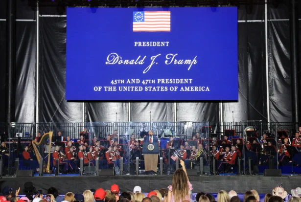 President Donald Trump speaks behind bulletproof glass during the kick-off celebration for the "Great American State Fair" on the National Mall in Washington on June 24, 2026. (Jemal Countess/AFP via Getty Images)