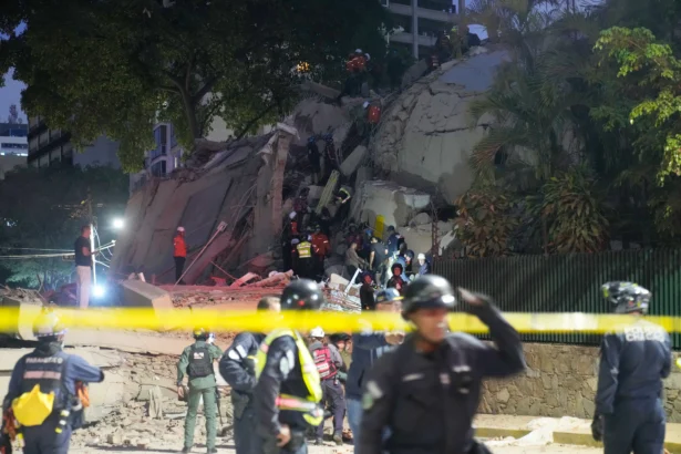 Rescue workers search for survivors at a collapsed building after an earthquake in Caracas, Venezuela, on June 24, 2026. (Ariana Cubillos/AP Photo)