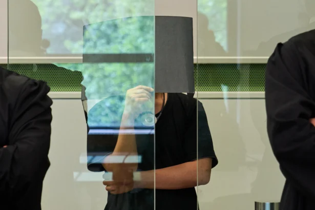 The defendant covering his face in the court during a trial against an online predator network of men accused of using chat groups to share tips on how to drug and rape women, in Berlin on July 8, 2026. (Ebrahim Noroozi/AP Photo)