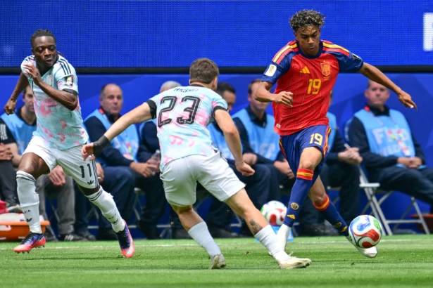 Belgium's midfielder #23 Nicolas Raskin and Spain's forward #19 Lamine Yamal fight for the ball during the 2026 World Cup football tournament quarter-final match between Spain and Belgium at the Los Angeles Stadium in Inglewood on July 10, 2026. (Frederic J. Brown/AFP via Getty Images)