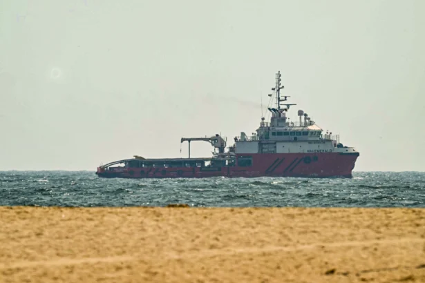 A ship sails off the coast of Ajman, United Arab Emirates on July 10, 2026. Shipping traffic through the Strait of Hormuz has fallen sharply following attacks on vessels earlier in the week and renewed military strikes between the United States and Iran. (AFP via Getty Images)