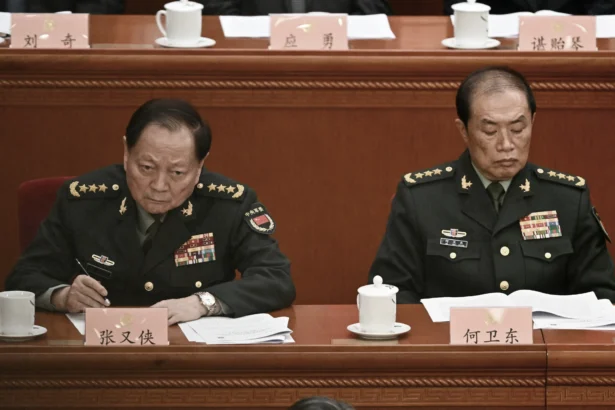 He Weidong (R), second-ranked vice chairman of China's Central Military Commission (CMC), and Zhang Youxia, first-ranked vice chairman of the CMC, attend the opening ceremony of the Chinese People's Political Consultative Conference in Beijing on March 4, 2025. (Pedro Pardo/AFP via Getty Images)