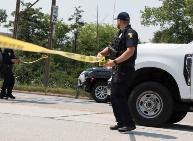 A Toledo police officer sets up a police line while responding to a hazardous material call in Toledo, Ohio, on July 15, 2026. (Alex Bracken/The Blade via AP)