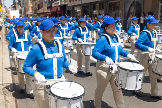 Falun Gong practitioners march during a parade calling for the end of the Chinese Communist Party’s 27 years of ongoing persecution against the spiritual practice, in New York City on July 19, 2026. (Mark Zou/The Epoch Times)