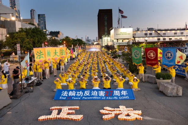 Falun Gong practitioners participate in a vigil in New York City to mark 27 years of the persecution of Falun Gong by the communist party in China on July 20, 2026. (Larry Dye/The Epoch Times)