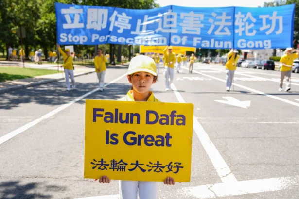 Falun Dafa practitioners take part in a march calling for the end of the Chinese Communist Party’s 27 years of persecution of Falun Gong in China, in Washington on July 23, 2026. (Samira Bouaou/The Epoch Times)