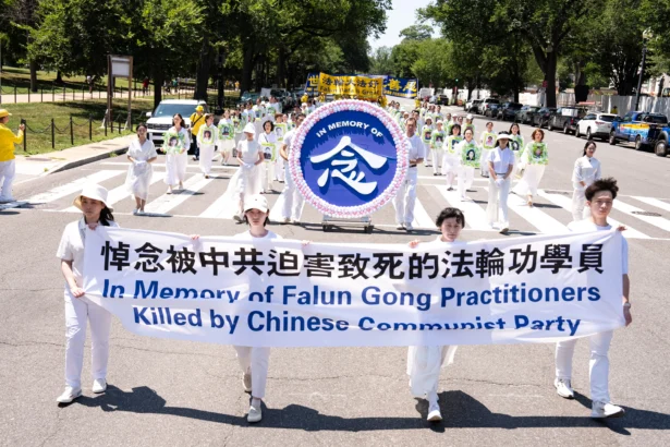 Falun Dafa practitioners take part in a march calling for the end of the Chinese Communist Party’s 27 years of persecution of Falun Gong in China, in Washington on July 23, 2026. (Larry Dye/The Epoch Times)