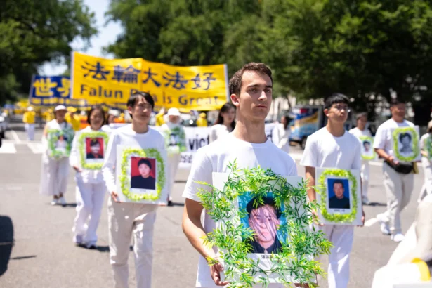 Falun Dafa practitioners take part in a march calling for the end of the Chinese Communist Party’s 27 years of persecution of Falun Gong in China, in Washington on July 23, 2026. (Larry Dye/The Epoch Times)