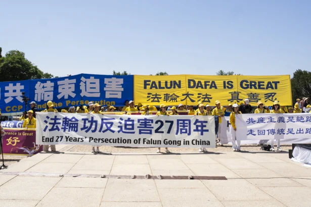 Falun Dafa practitioners take part in the annual rally calling for the end of the Chinese Communist Party’s ongoing persecution of Falun Gong in China, at the Lincoln Memorial in Washington on July 23, 2026. (Madalina Kilroy/The Epoch Times)