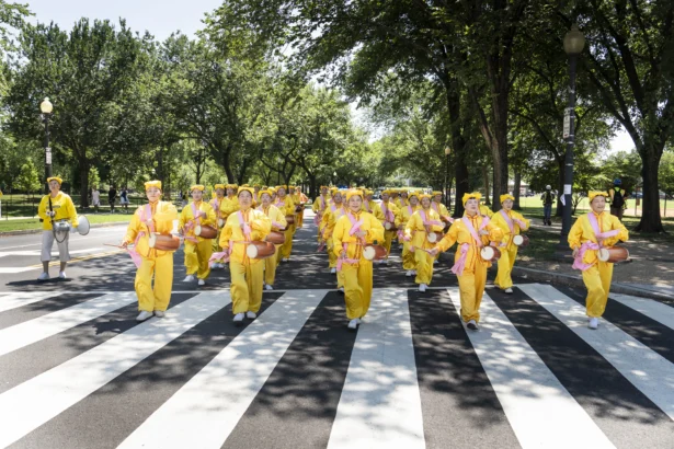 Falun Dafa practitioners take part in a march calling for the end of the Chinese Communist Party’s 27 years of persecution of Falun Gong in China, in Washington on July 23, 2026. (Madalina KilroyThe Epoch Times)