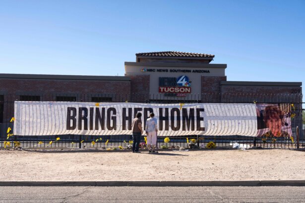 People visit a banner for Nancy Guthrie, the missing mother of "Today" show host Savannah Guthrie, outside the KVOA Newsroom in Tucson, Ariz., on March 6, 2026. (Rebecca Noble/AP Photo)