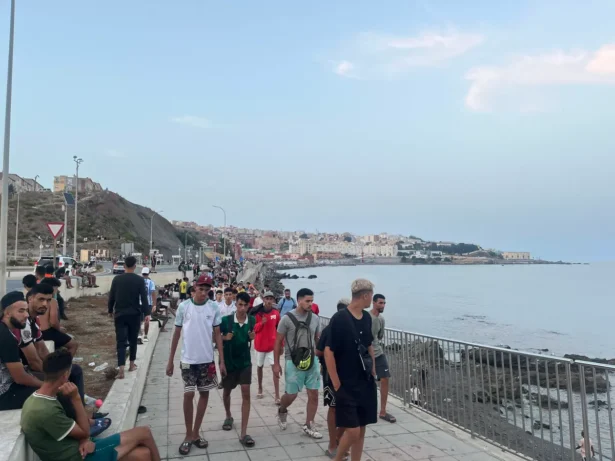 Moroccan illegal immigrants walk along Avenida Martínez Catena in Ceuta toward the border area on July 31, 2026, at 9:34 p.m. local time. (Etienne Fauchaire/The Epoch Times)