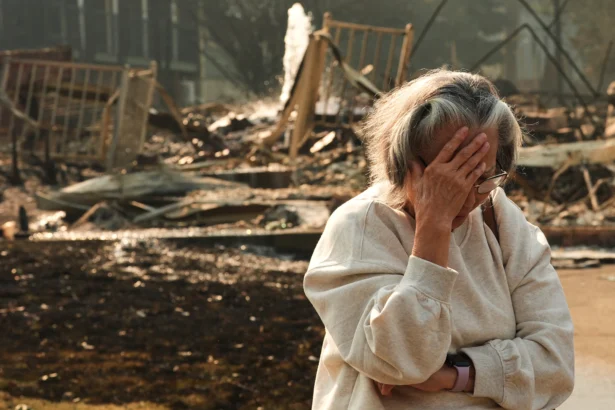 Miriam Sim, 76, reacts while talking about her neighborhood largely burning to the ground after a wildfire hit the northern part of Spokane, Wash., on Aug. 3, 2026. (Lindsey Wasson/AP Photo)
