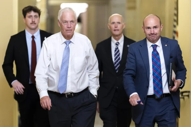 (L–R) Sen. Ron Johnson (R-Wis.), Sen. Rick Scott (R-Fla.), and Sen. Mike Lee (R-Utah) walk towards Senate Chambers in the U.S. Capitol Building in Washington on Aug. 7, 2026. (Finn Gomez/Getty Images)