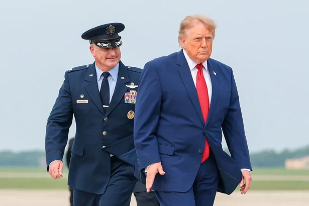 President Donald Trump is accompanied by U.S. Air Force Col. Christopher M. Robinson as he walks to board Air Force One at Joint Base Andrews, Md., on Aug. 11, 2026. (Anna Moneymaker/Getty Images)