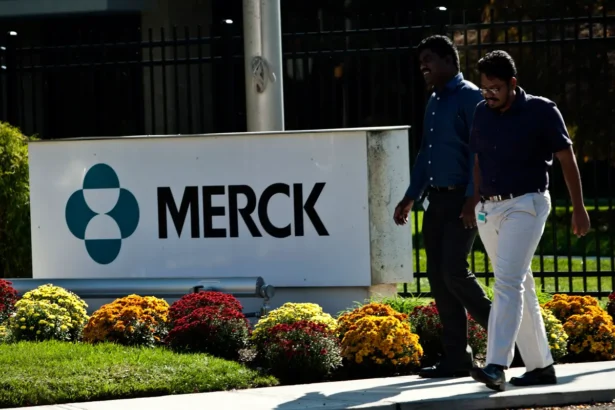 Employees walk past a Merck sign in front of the company's building in Summit, N.J., in an undated file photograph. (Kena Betancur/Getty Images)