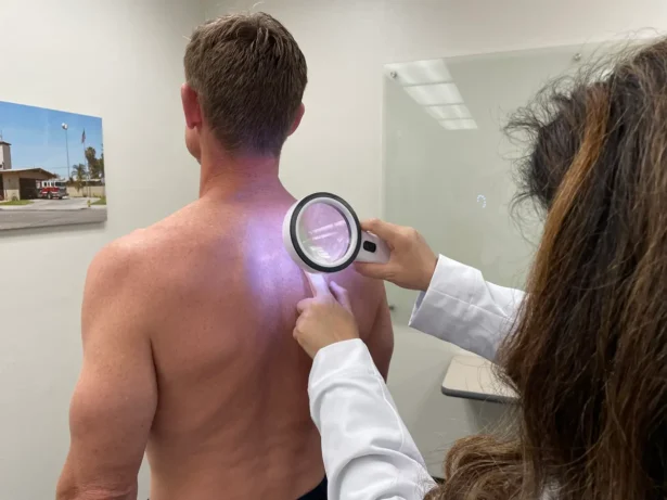 A doctor performs a skin cancer spot screening on a firefighter in Huntington Beach, Calif., on April 30, 2023. (Sophie Li/The Epoch Times)