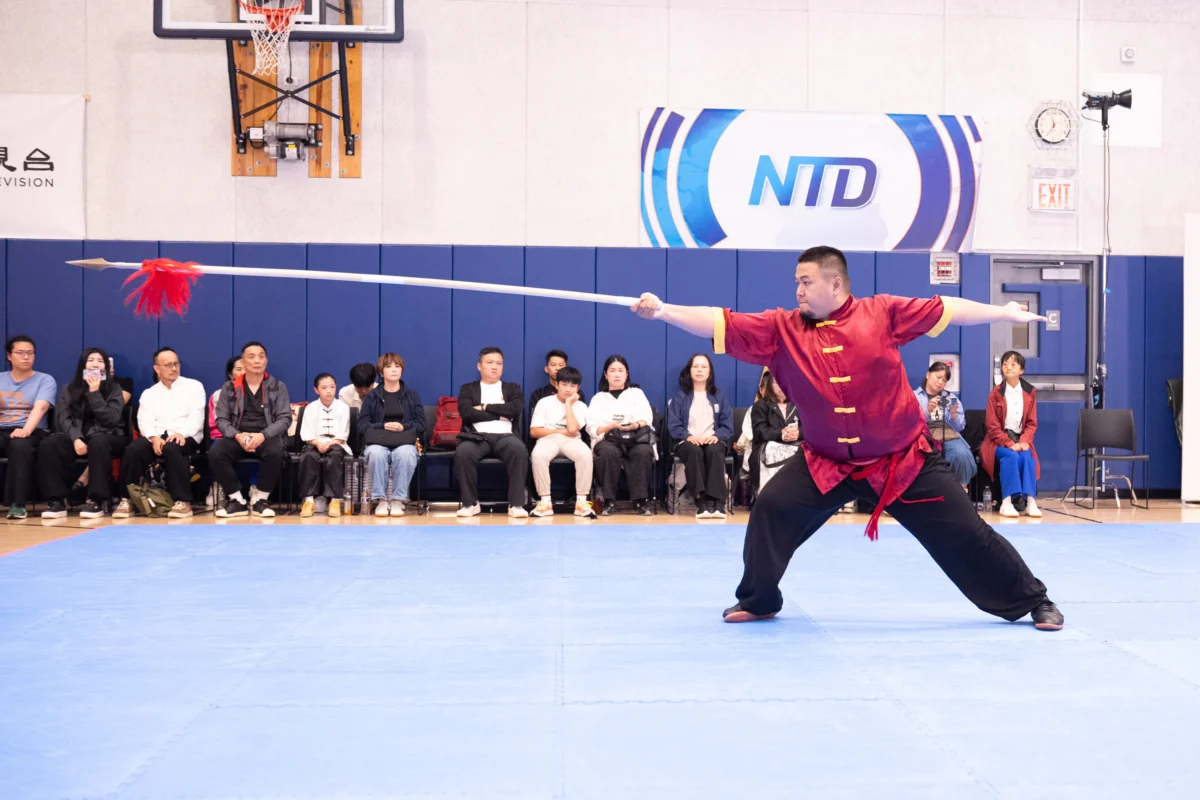 Chen Shaoxuan of Taiwan performs the Shaolin Great Six Harmonies Spear in the men's weapons final in Manhattan on Aug. 15, 2026. (Larry Dye/The Epoch Times)