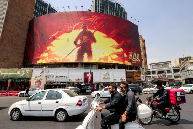 Traffic in front of a political billboard at Valiasr Square in central Tehran, Iran, on August 8, 2026. (Atta Kenare/AFP via Getty Images)