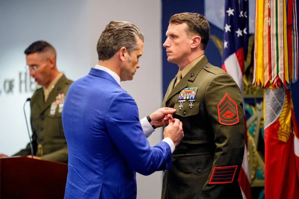 Secretary of War Pete Hegseth (L) pins a medal on Marine GySgt. Jonathan Eby (R) during an event to honor Marines who were serving during the 2021 Abbey Gate bombing, at the Pentagon in Arlington, Va., on Aug. 26, 2026. (Andrew Harnik/Getty Images)
