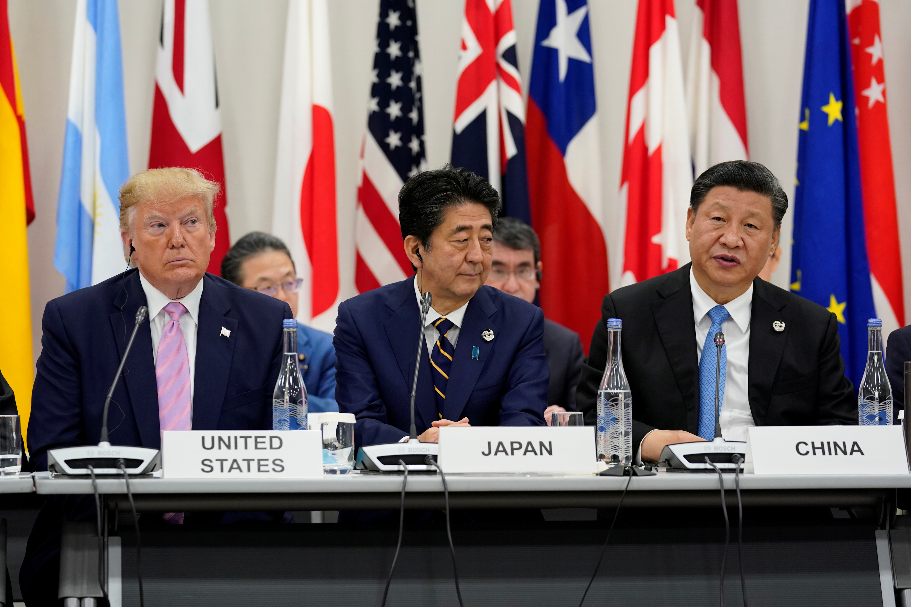 Japan's Prime Minister Shinzo Abe is flanked by U.S. President Donald Trump and Chinese leader Xi Jinping during a meeting at the G20 leaders summit in Osaka, Japan on June 28, 2019. (Kevin Lamarque/Reuters)