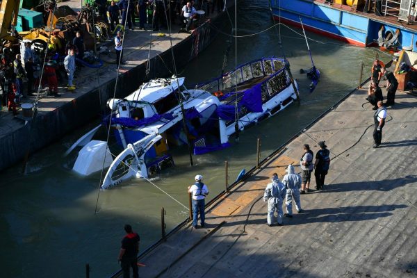 The sunk shipwreck surfaces during the recovery operation at Margaret Bridge, the scene of the fatal boat accident in Budapest, Hungary, on June 11, 2019.(Marton Monus/MTI via AP)