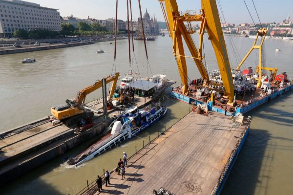 A crane lifts the sightseeing boat out of the Danube river in Budapest, Hungary, on June 11, 2019. (Darko Bandic/AP Photo)