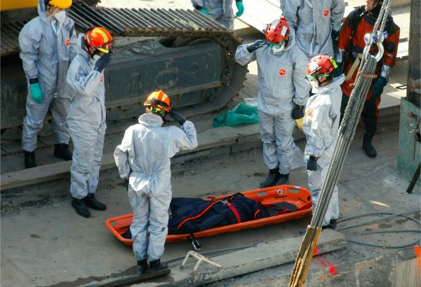 Rescue team members salute next to a recently found victim during the recovery operation at Margaret Bridge, the scene of the fatal boat accident in Budapest, Hungary, on June 11, 2019. (Balazs Mohai/MTI via AP)