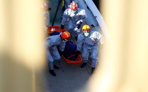 Members of a South Korean rescue team carry the body from the sightseeing boat after lifting out of Danube river in Budapest, Hungary, on June 11, 2019. (Darko Bandic/AP Photo)